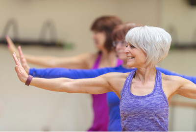 Image of a senior lady partaking in holistic fitness training.