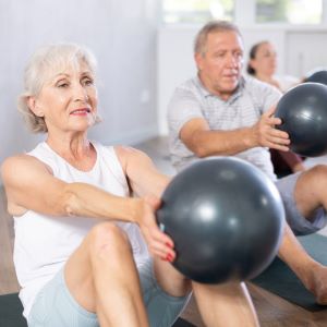 Image of seniors exercising with medicine balls.