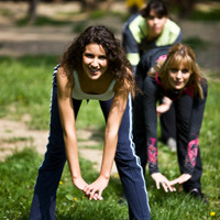 Image of participants engaging in an outdoor fitness training session.