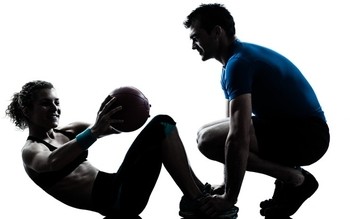 Image of a personal trainer working with a client.