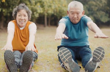 Image of a senior couple exercising outdoors together.