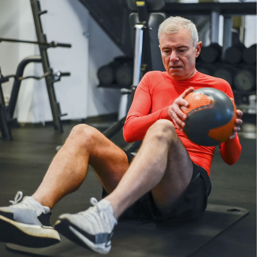 Image of a senior man performing functional fitness training.
