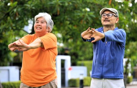 Image of a senior couple exercising outdoors.