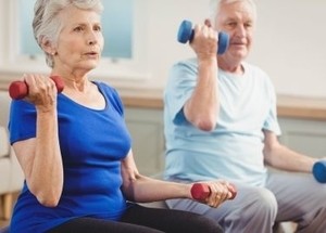 Image of an older couple working-out at home together.
