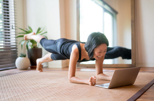 Image of a mid-life woman in the midst of live, virtual personal training.