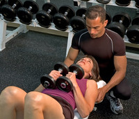 Image of a standard fitness trainer training a client.