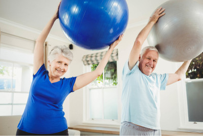 Image of a senior couple exercising with exercise balls.